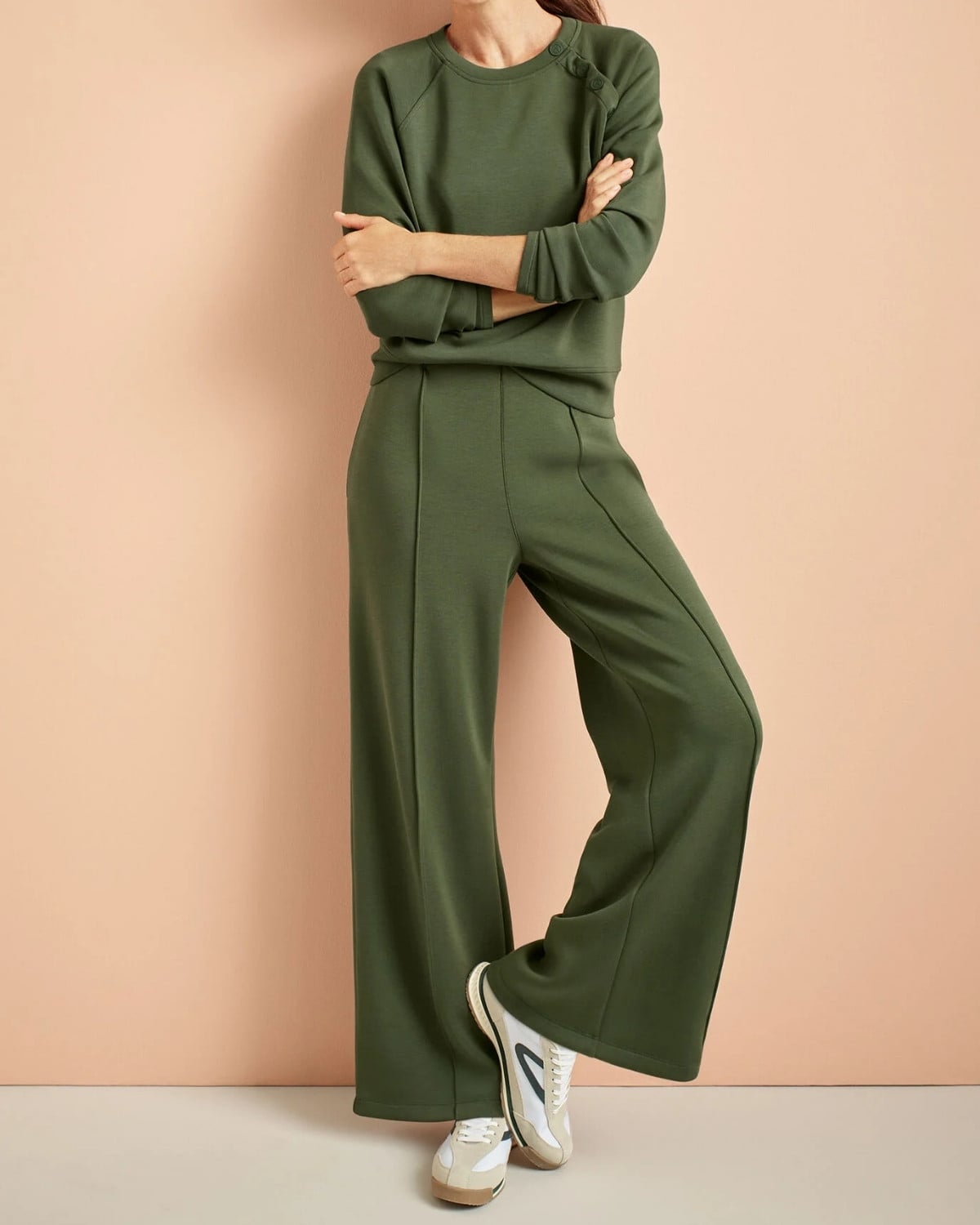 Green matching lounge set with comfortable sneakers for a travel day or casual New York City outfit.