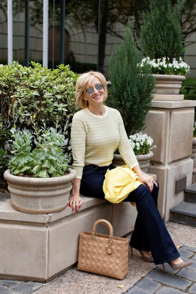 yellow sweater blue flare jeans