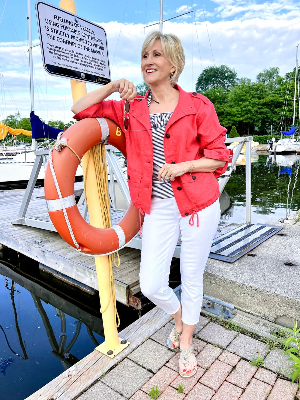 coral linen jacket with blue and white striped top, white jeans