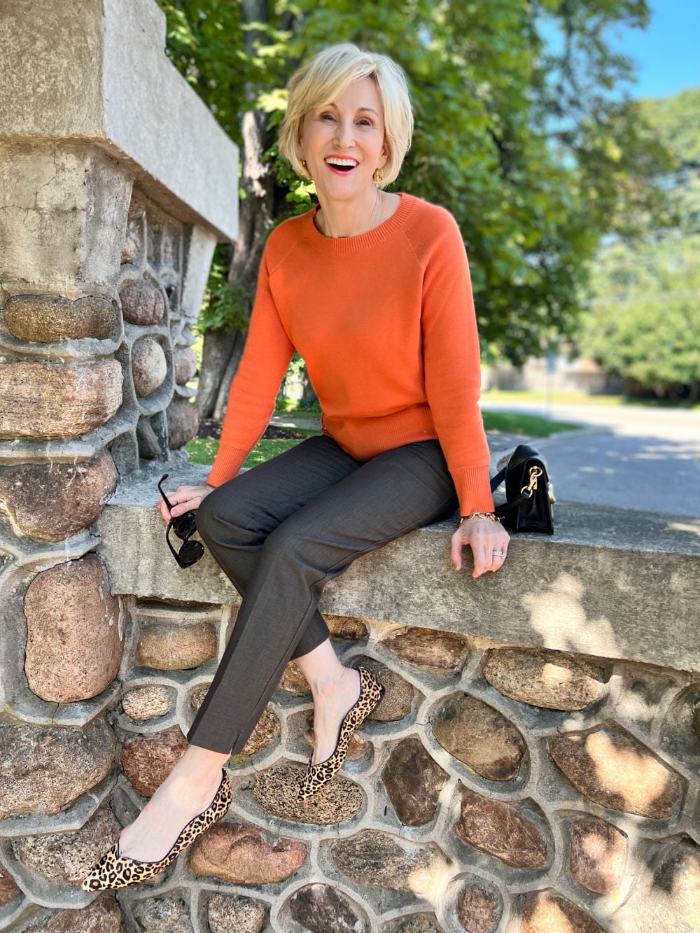 orange sweater, brown dress pants
