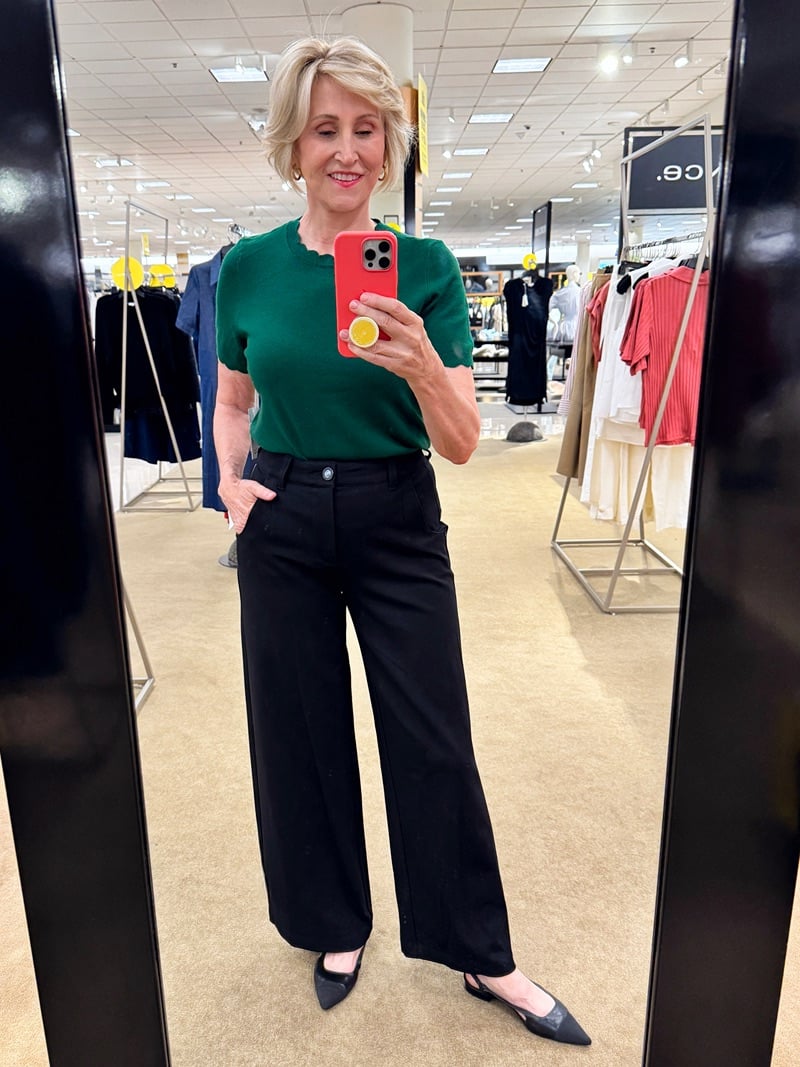 Green sweater, black pants