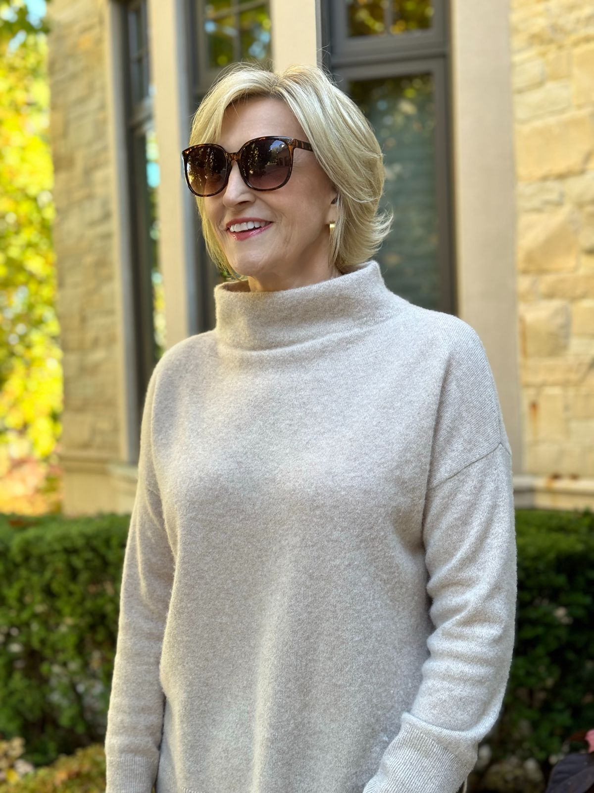 taupe funnel neck sweater worn by Deborah Boland of Fabulous After 40