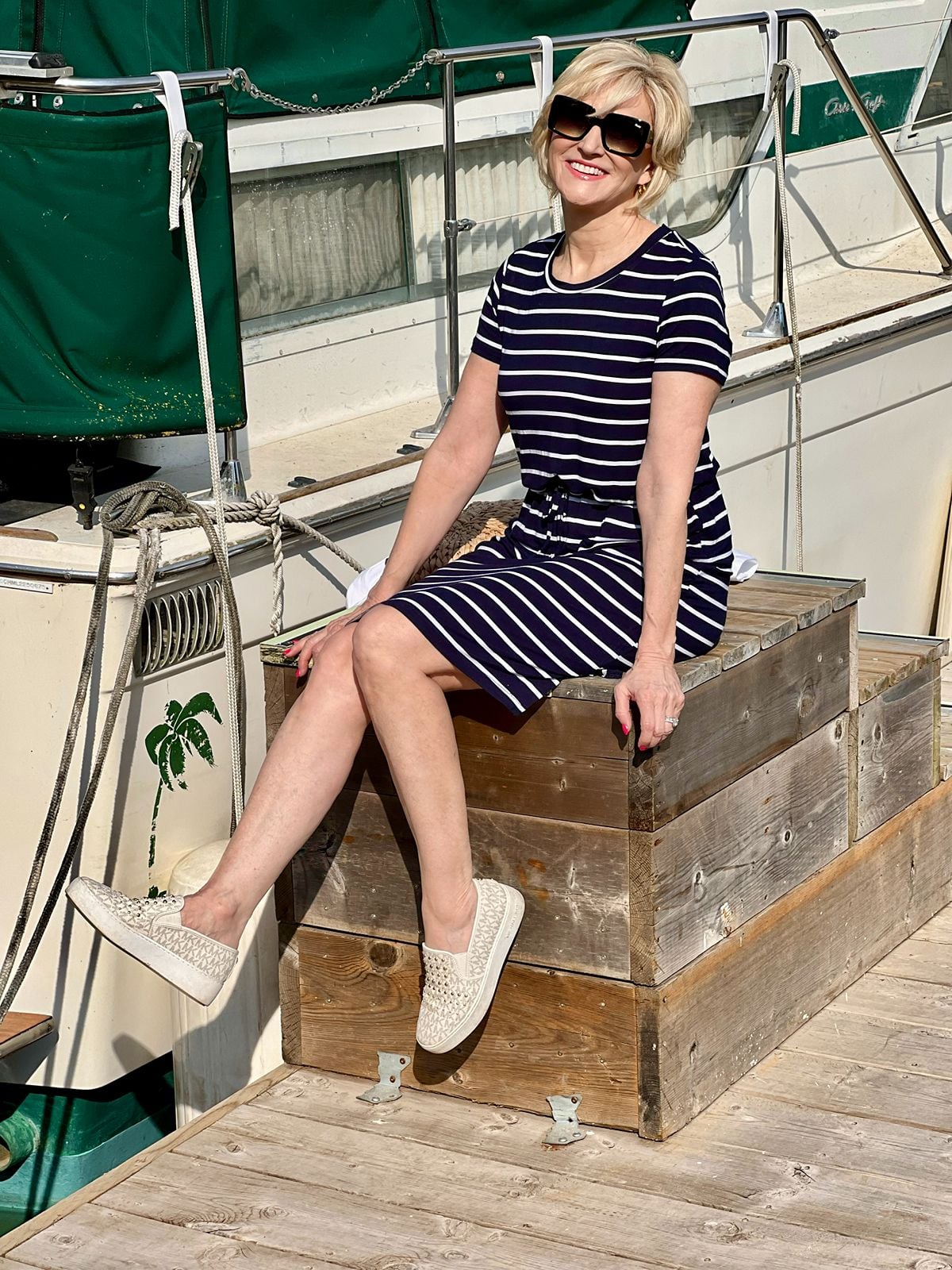 Deborah wearing a casual striped dress with fashion sneakers for a comfortable everyday look