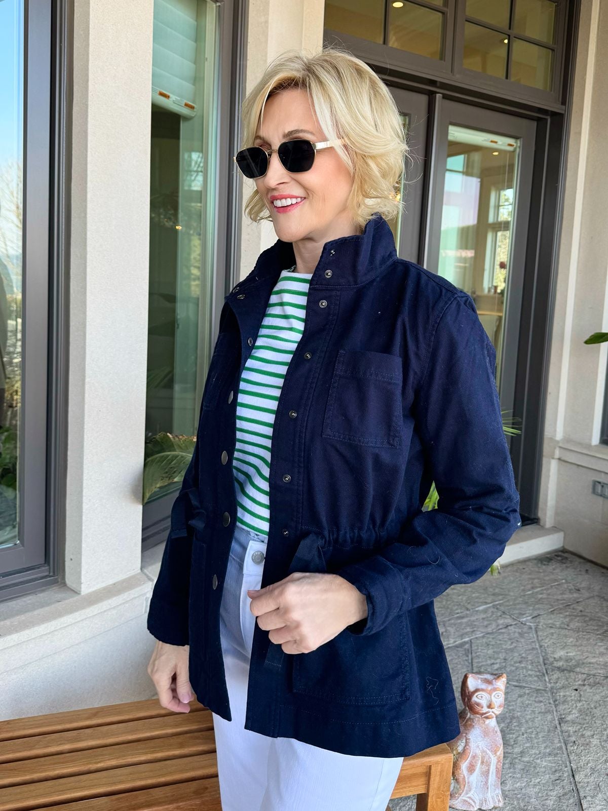 Woman wearing navy utility jacket with white tee and jeans for a casual spring outfit