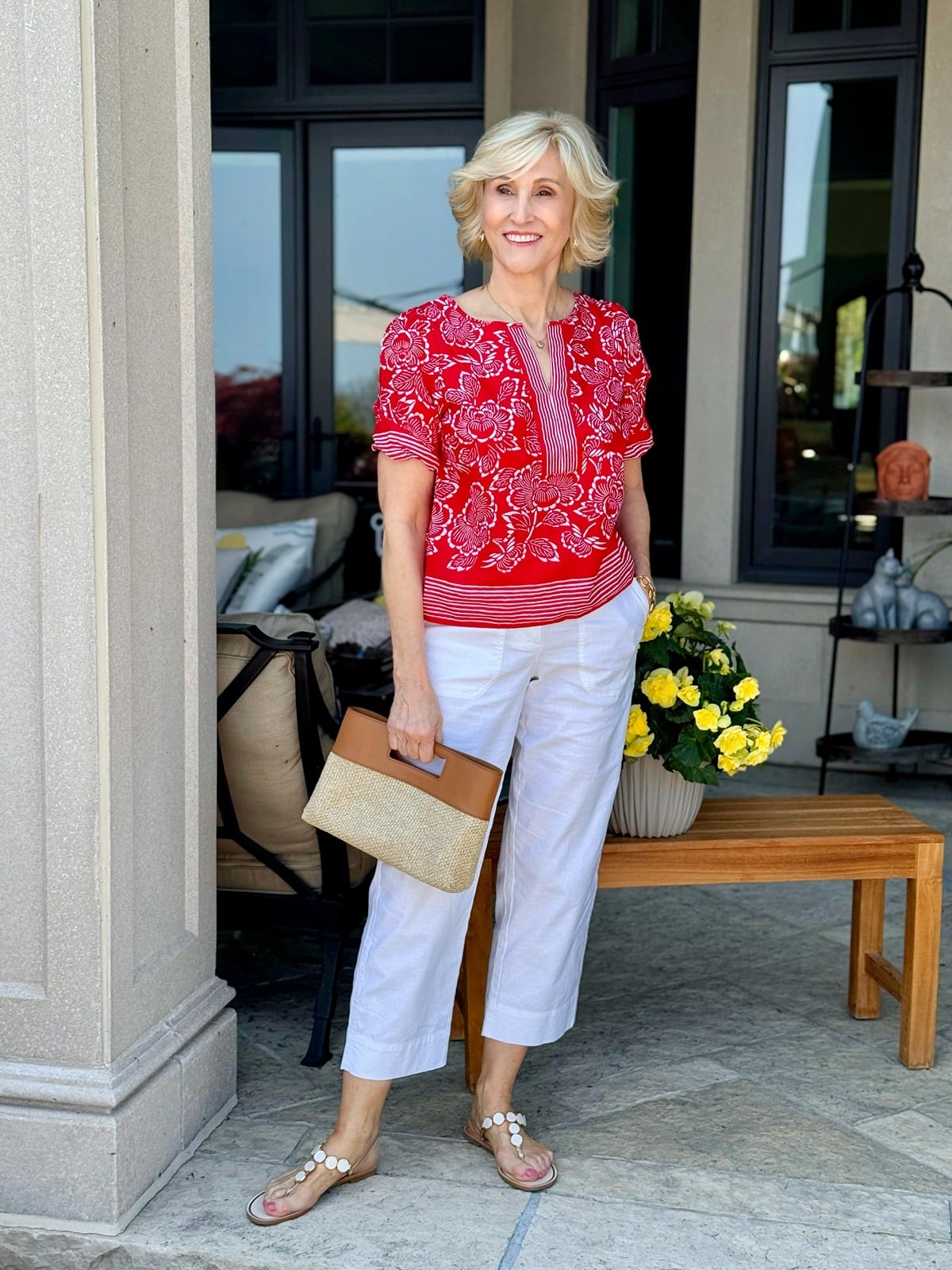 red floral blouse with white capri pants and neutral embellished sandals, stylish summer shoes to wear with capris for women over 50