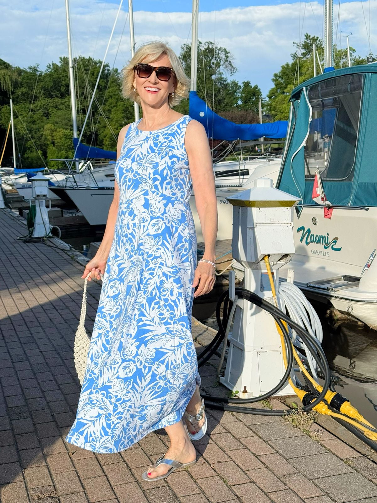 Deborah Boland wearing a blue floral maxi dress with flat sandals as a stylish summer alternative to shorts
