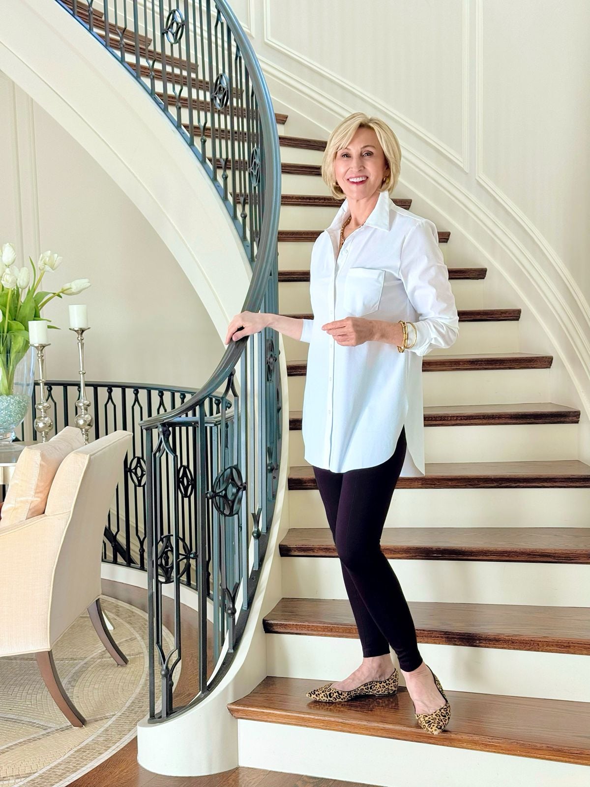 White tunic shirt for women styled with black leggings and leopard flats