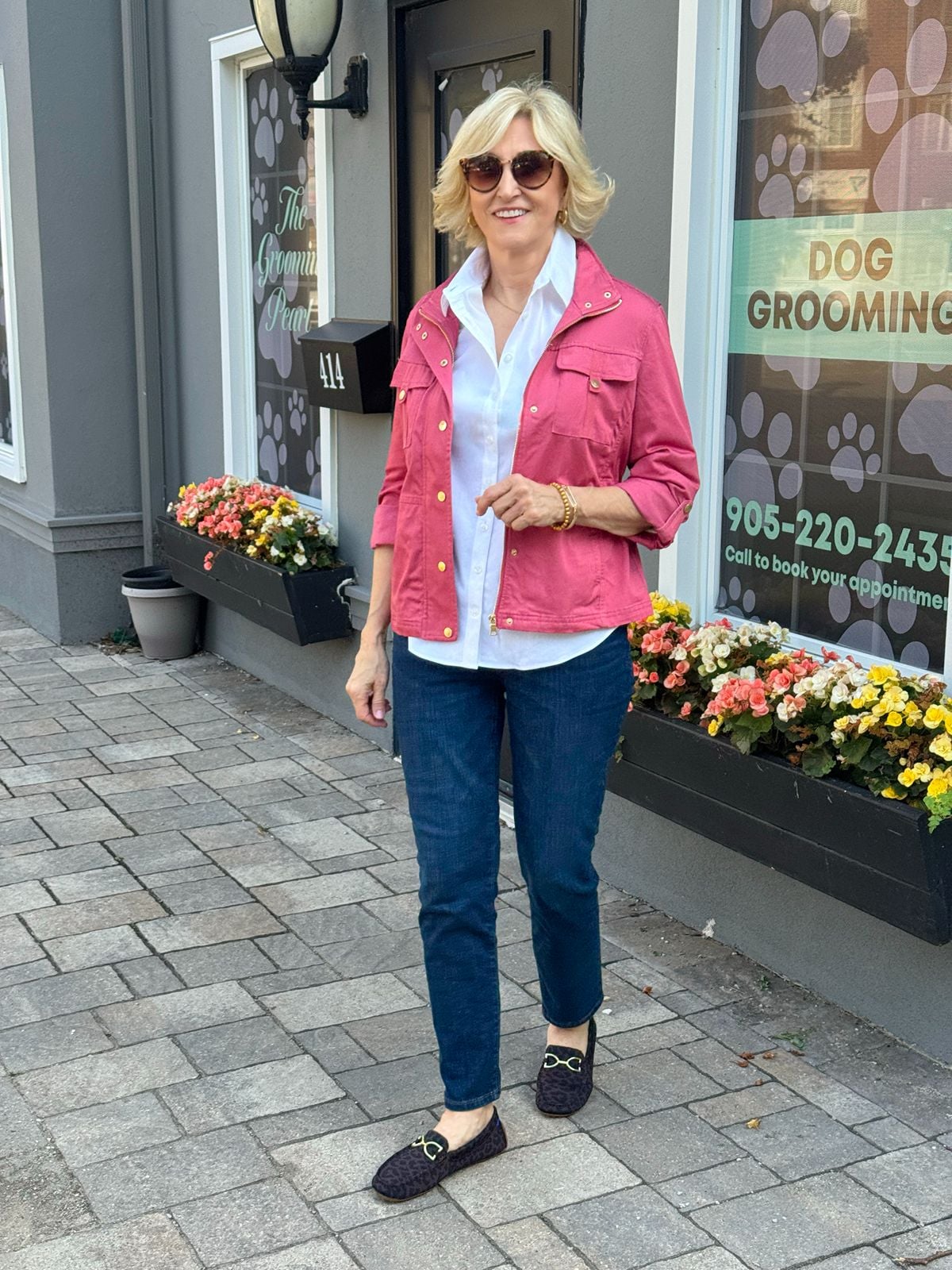 White button-down shirt for women layered under a pink jacket with jeans